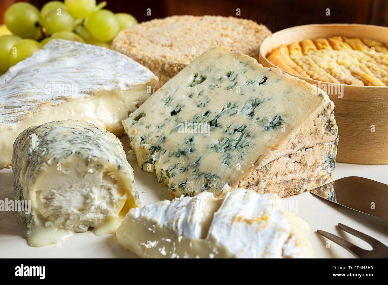 French cheese - camembert, roquefort, brie, goat cheese and epoisse with grapes close-up Stock Photo