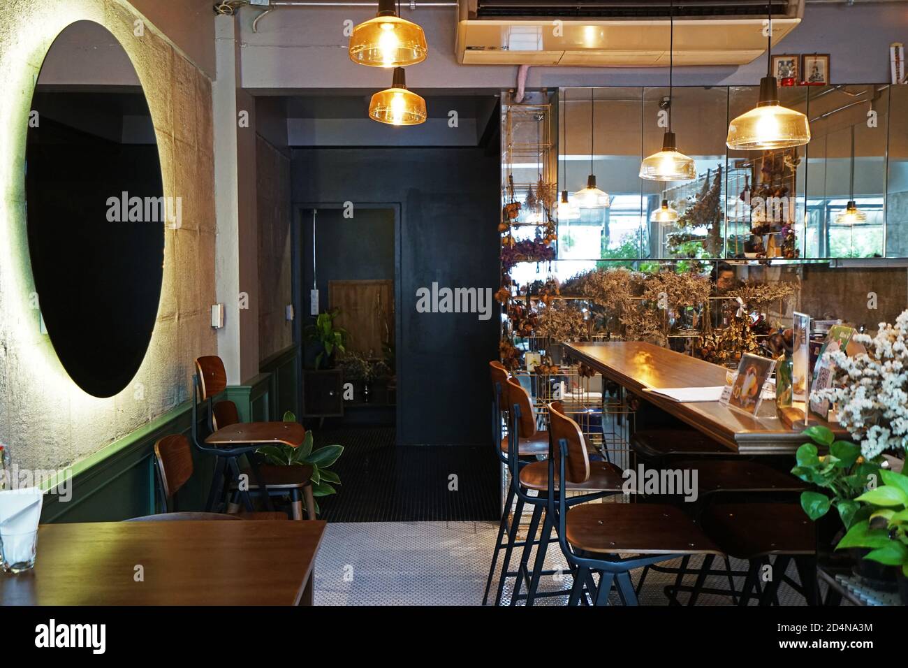 Interior design and decoration of coffee cafe and bakery shop decorated  with indoor flower plant and wooden furniture Stock Photo - Alamy