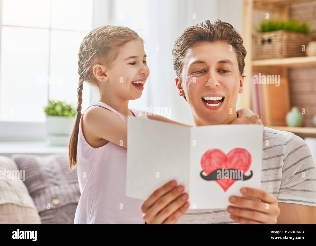 Happy father's day! Child daughter congratulates dad and gives him ...