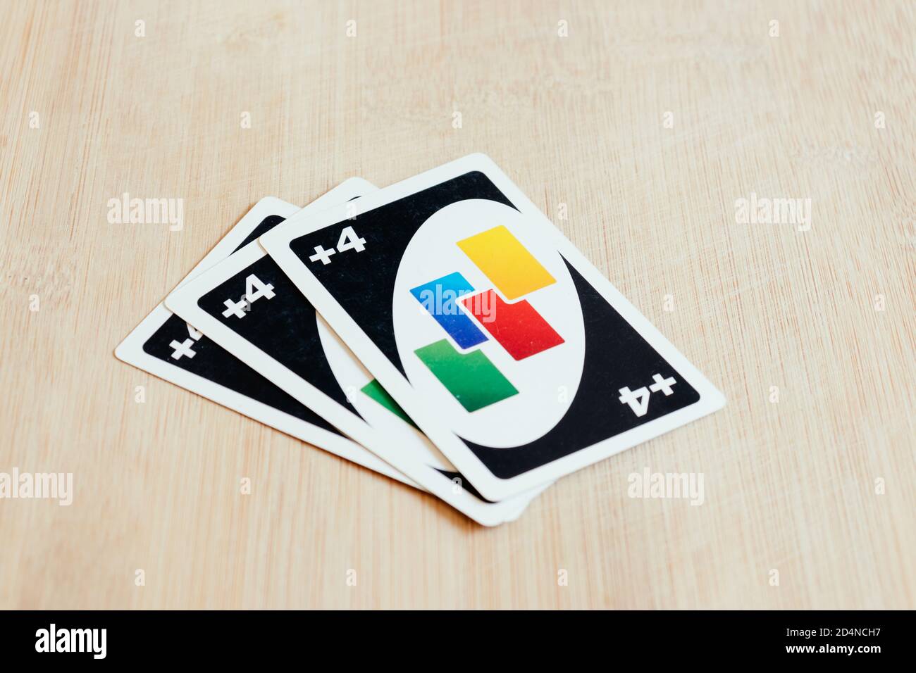 Uno draw 4 cards lying on a desk. Stock Photo