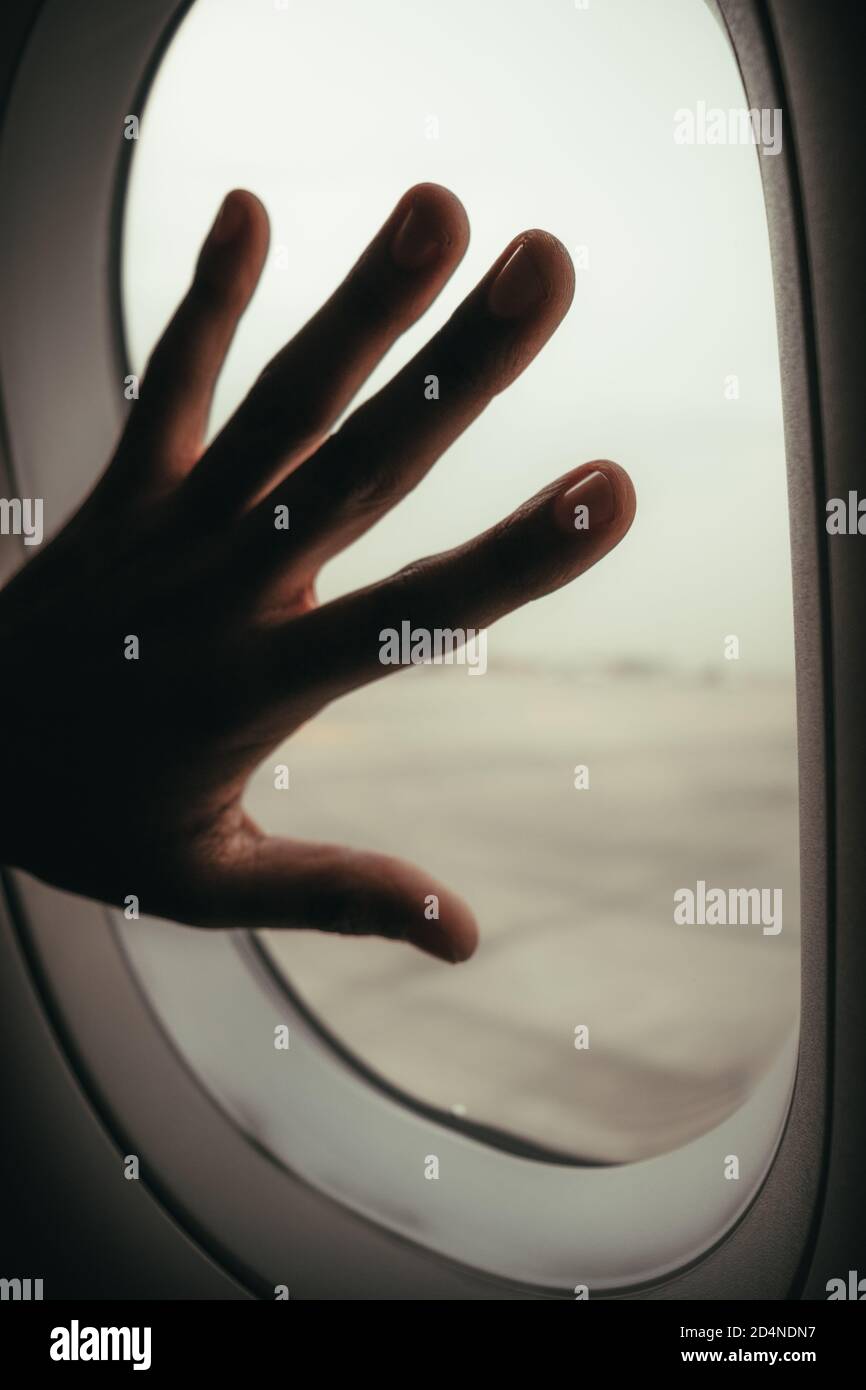 hand on an aeroplane window Stock Photo