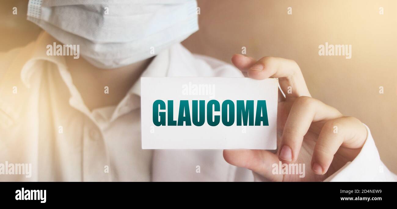 Doctor in medical clothes on a light background with the text Glaucoma. Selective focus. Medical concept Stock Photo