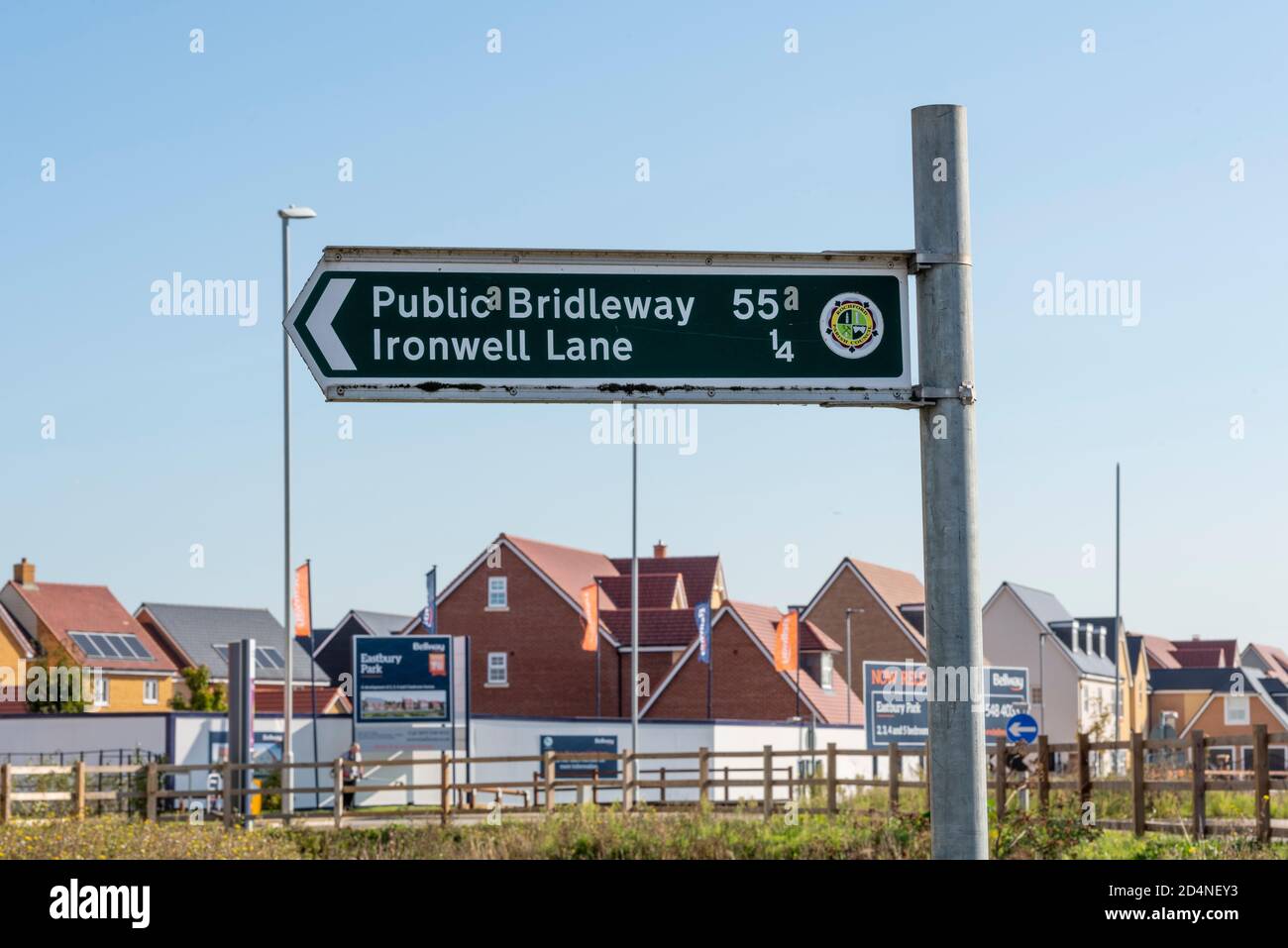 Public bridleway 55 to Ironwell Lane byway towards Hawkwell in Rochford, Essex, UK. Green sign. Signpost. Close to new housing development Stock Photo