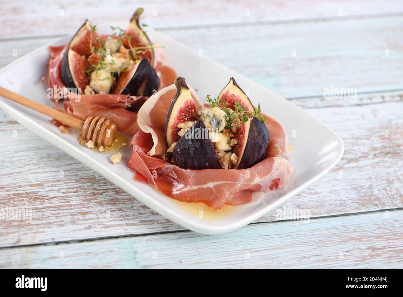 Figs stuffed with blue cheese, wrapped in Parma ham, drizzled with