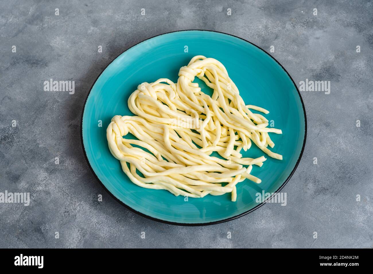 Braided cheese pigtail. Traditional polish salty string cheese Stock