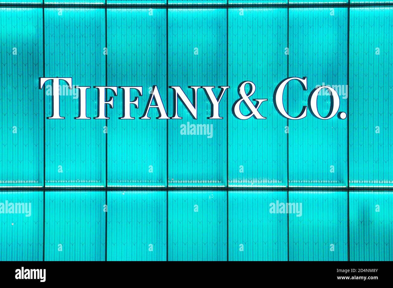 An illuminated shop sign for the high end luxury designer shop of Tiffany & Co Stock Photo