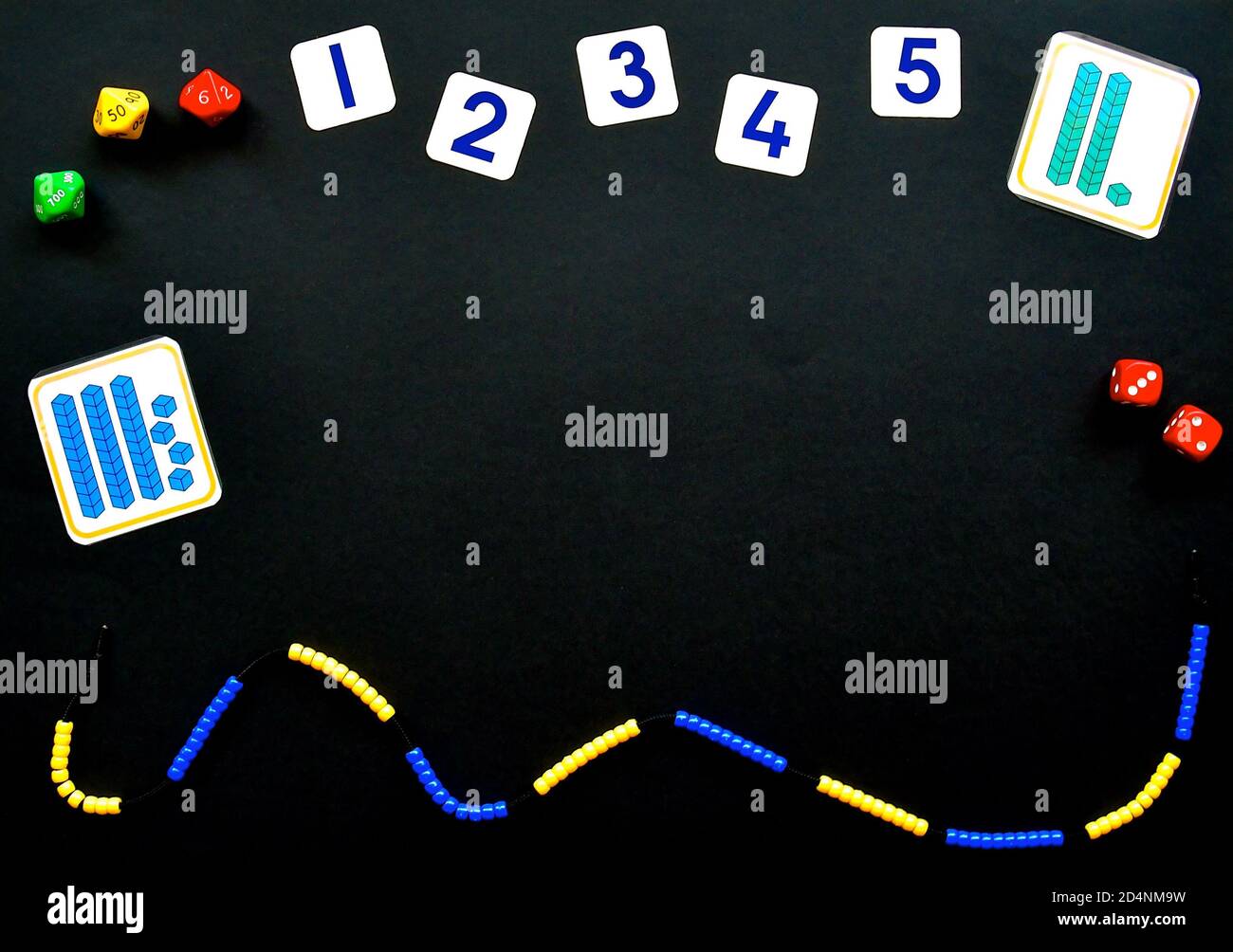 Maths concept flatlay on a black background with copyspace, focusing on number, addition, sibtraction and counting with beaded number lines, place val Stock Photo