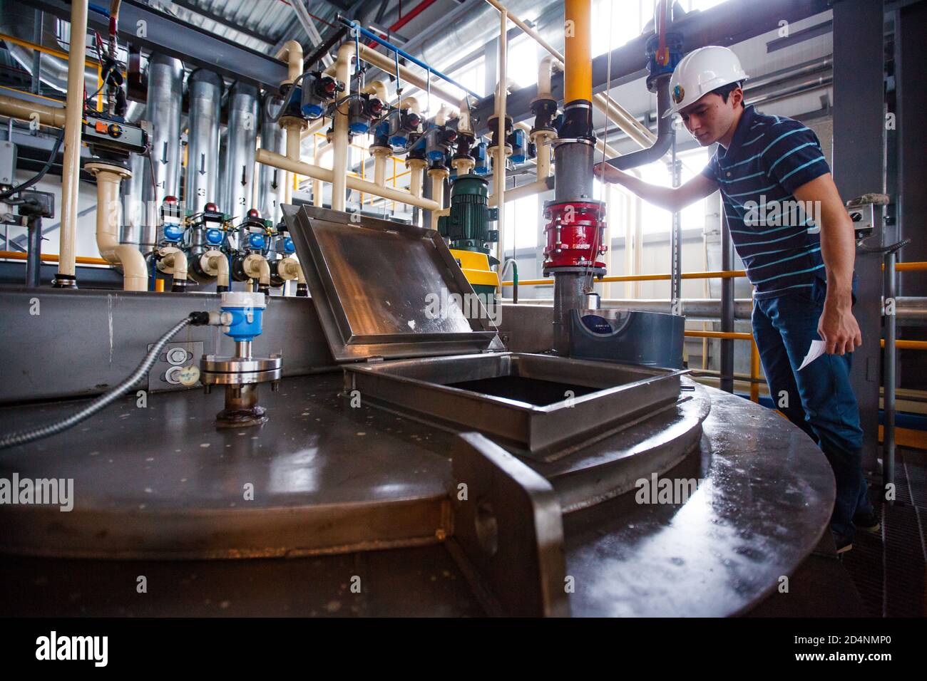 Motor oil modern production plant. Engineer controls processing. Oil