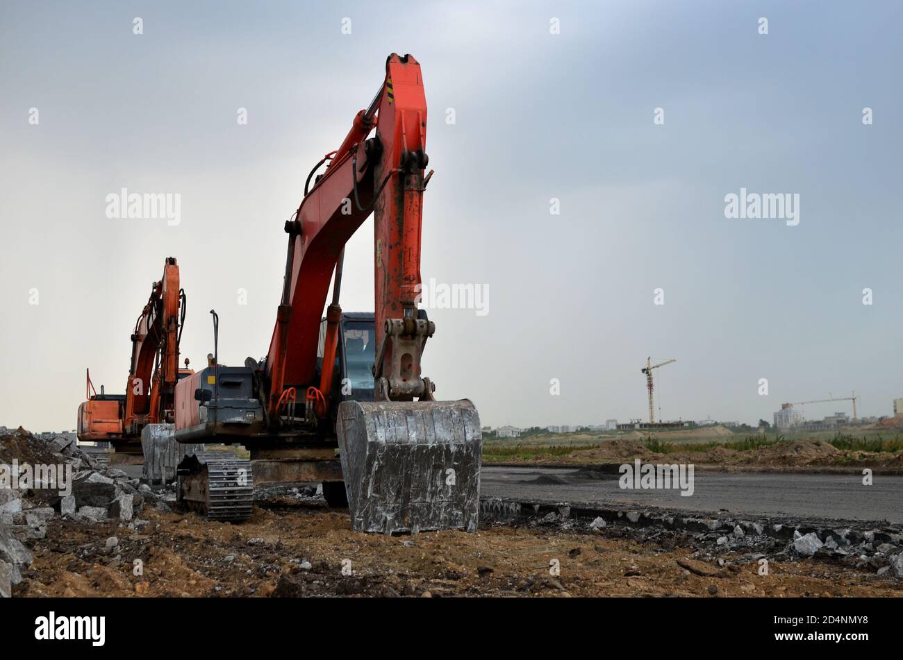 Excavator work with old asphalt or concrete waste on construction site