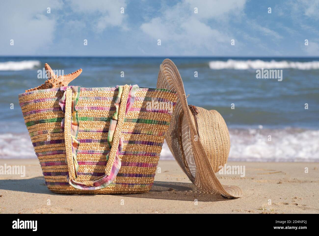 Women's hat and bag on the beach Stock Photo Alamy