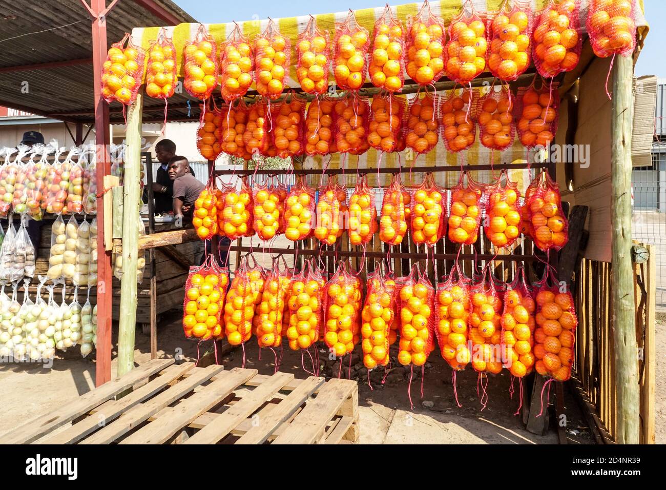 fruit and veg street vendor and stall with bags of citrus fruit or