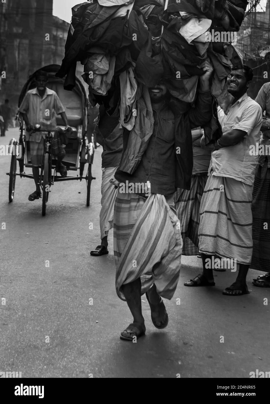 Day labour smiling with heavy weight , but he is happy as he earning in legal way . I captured this image from Dhaka, Bangladesh, Asia. Stock Photo