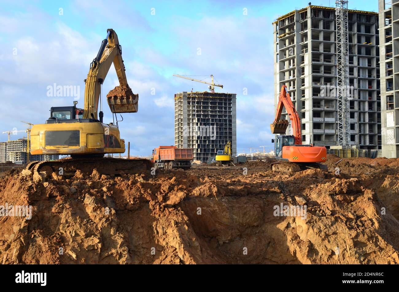 Group of the excavators for dig ground trenching at a construction site