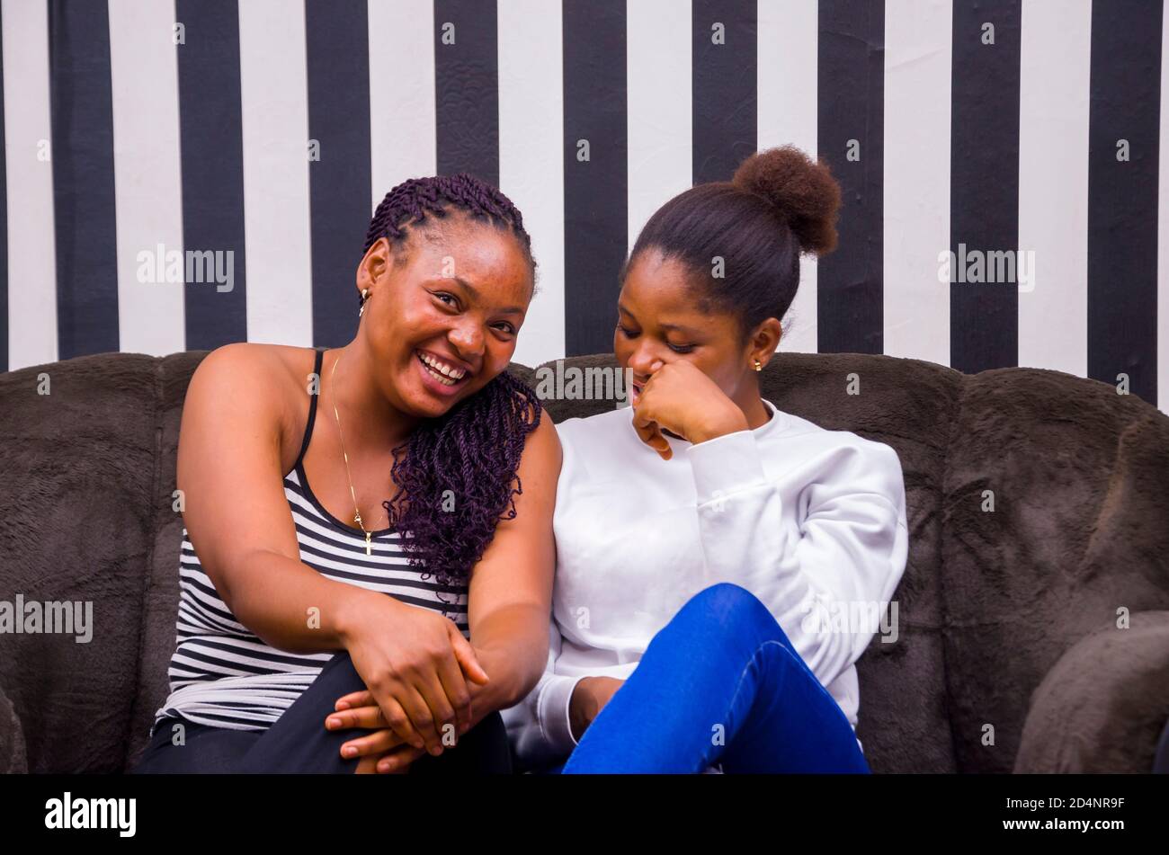 two beautiful african ladies feeling happy as they discuss. Stock Photo