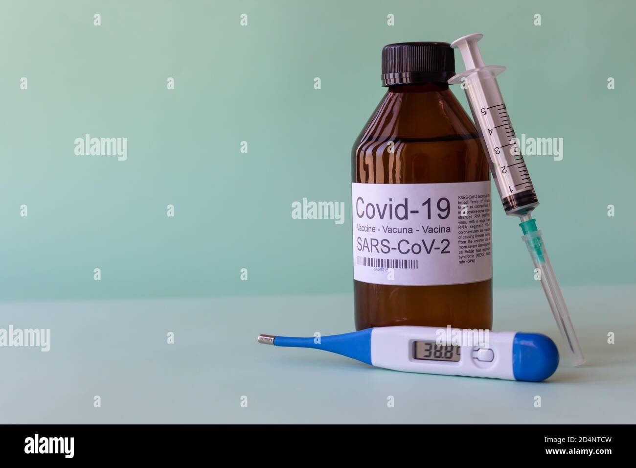 Closeup shot of the COVID-19 vaccine with a discardable syringe and digital thermometer Stock Photo