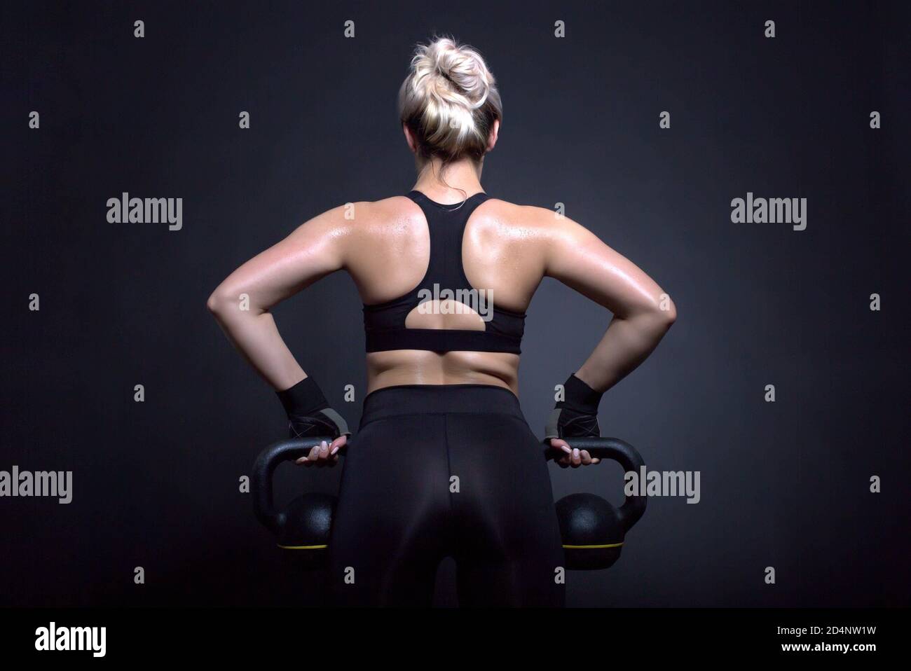 sexy fitness lady poses, black background studio Stock Photo