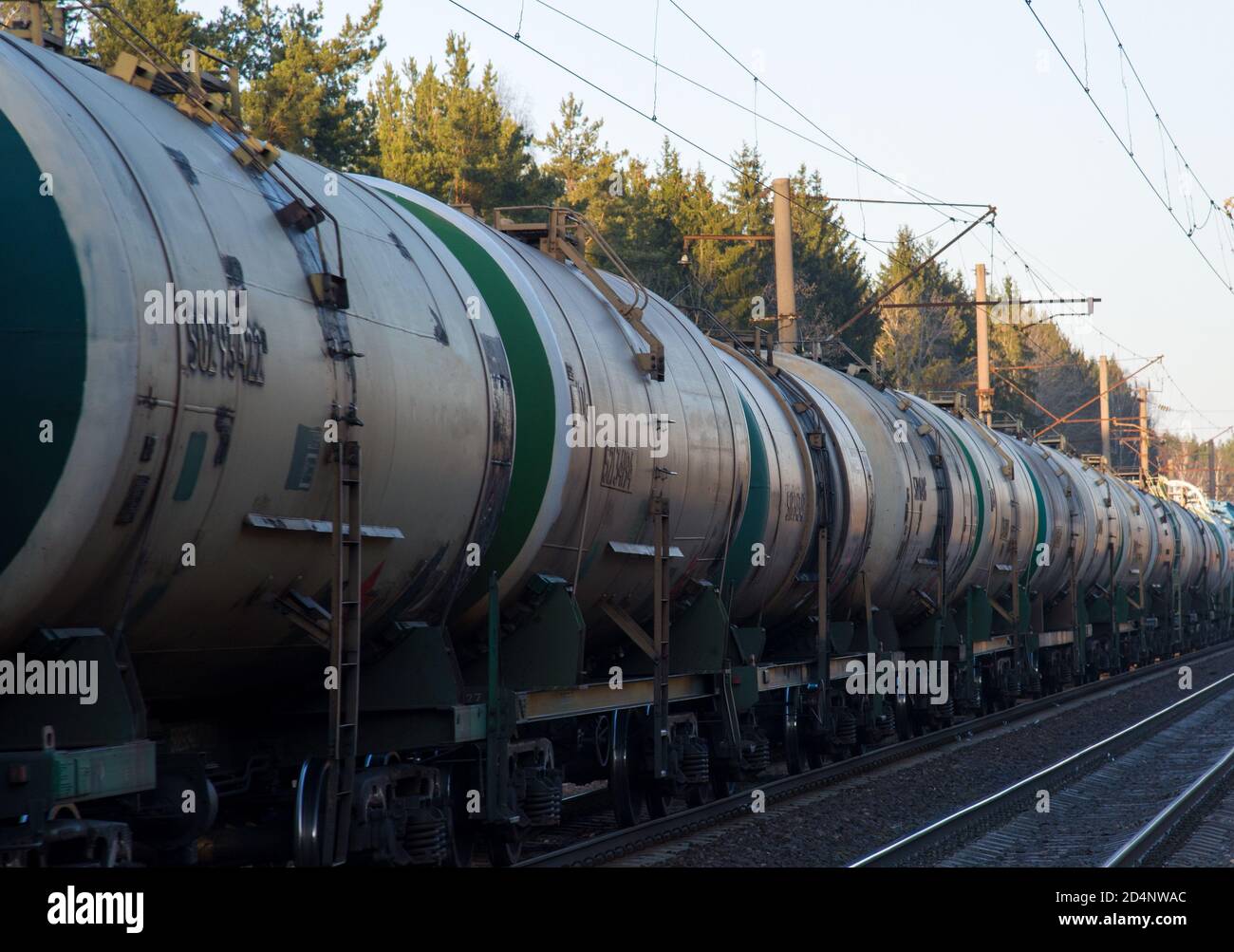 Freight train with petroleum tank cars on railroad. Rail cars carry oil