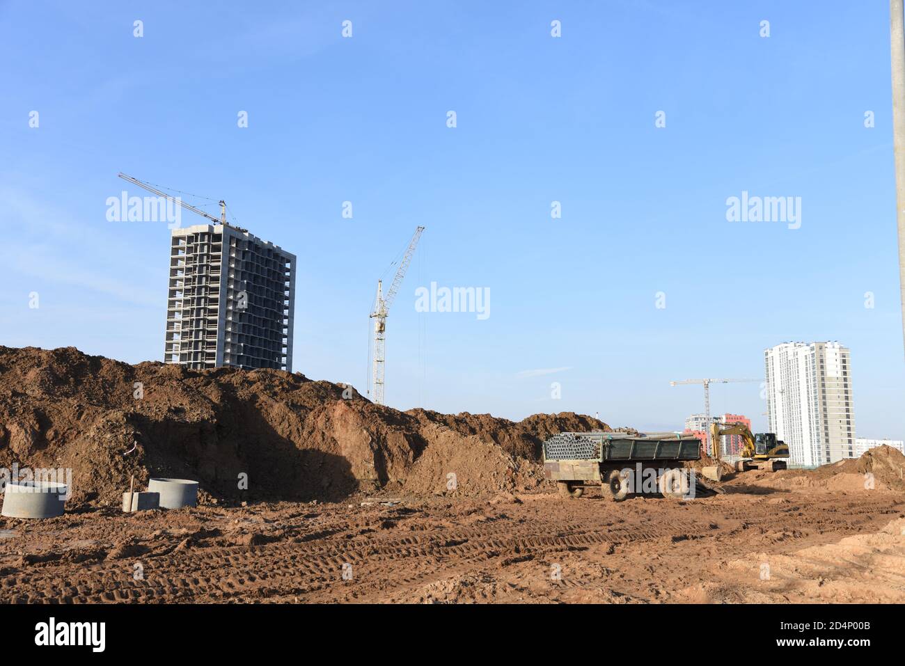 Road construction at the large scale construction site on tower cranes