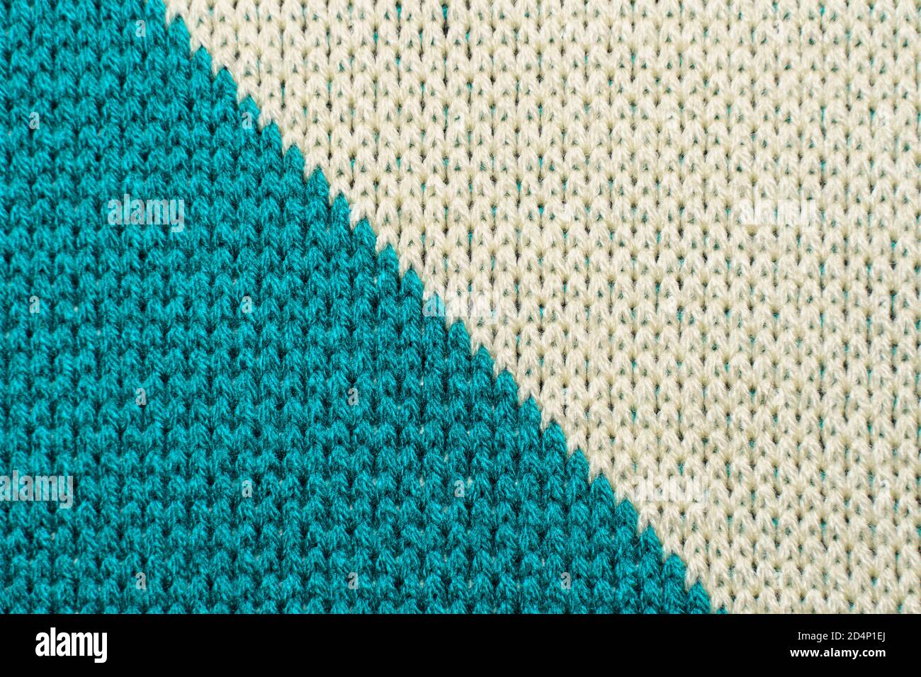 Blue and white synthetic knitted fabric close up. Knitted diagonal pattern fabric texture background Stock Photo