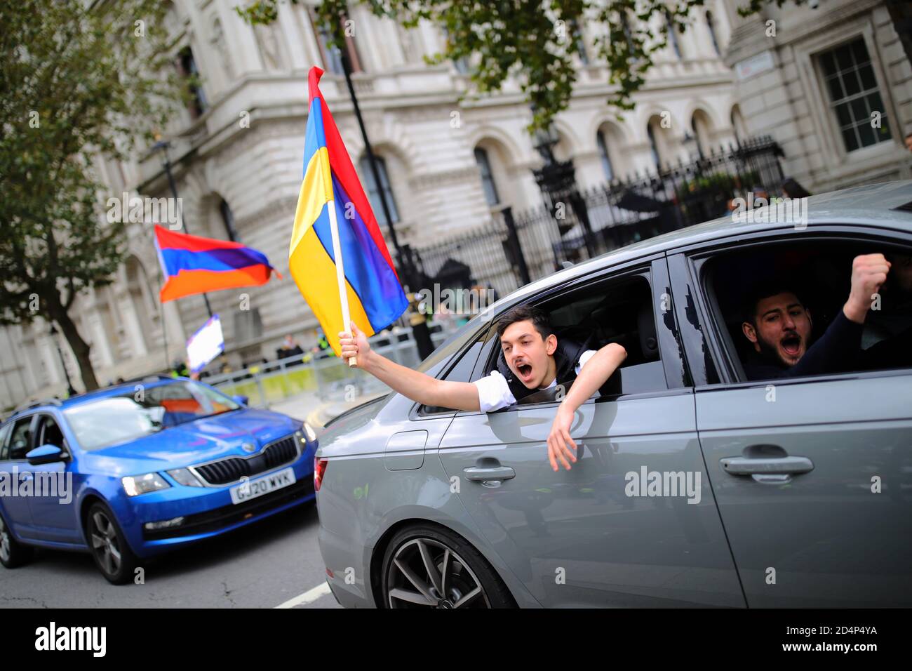 Pro-Armenian protesters waving an Armenian flag from a car, in Whitehall, London. The protest comes as Armenia and Azerbaijan have agreed to a ceasefire in Nagorno-Karabakh, despite claims by both sides that the other has breached the ceasefire. Stock Photo