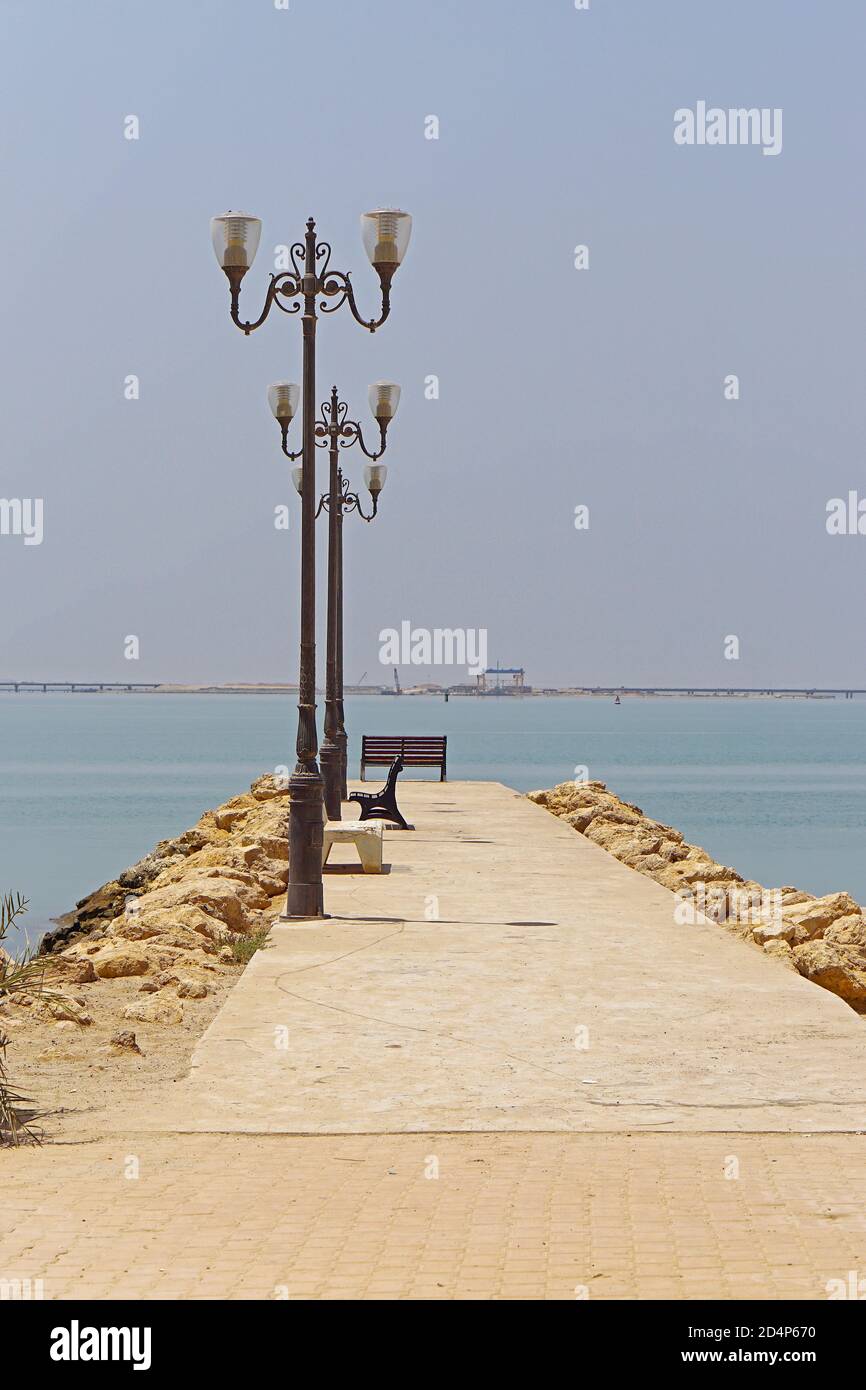 Long empty concrete pier jetty in Kuwait Stock Photo