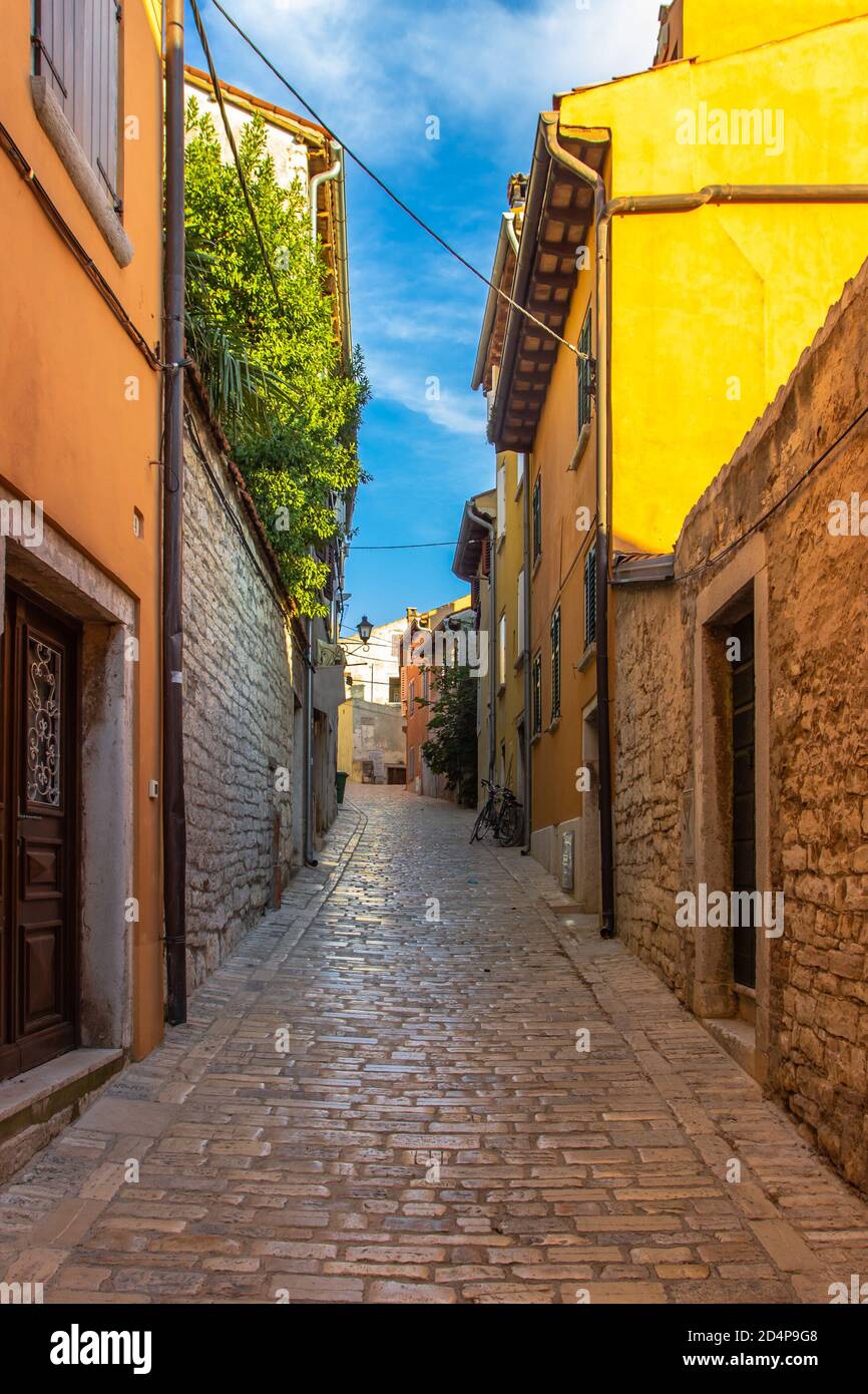 Morning walk in empty Croatian city of Rovinj.Picturesque narrow cobblestone streets,colorful facades,small shops,beautiful European cityscape.Summer Stock Photo