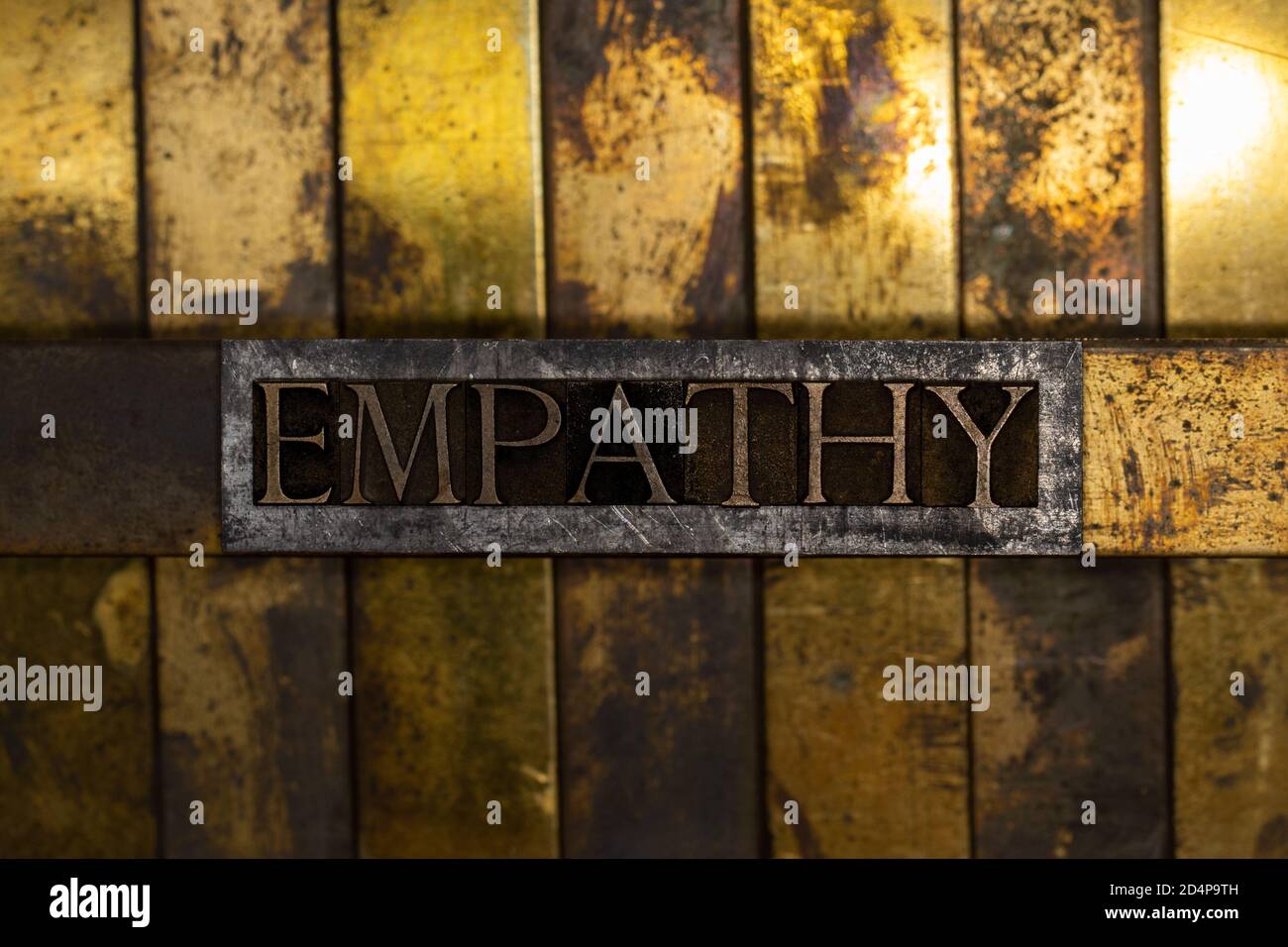 Empathy text message on vintage textured grunge copper and gold background Stock Photo
