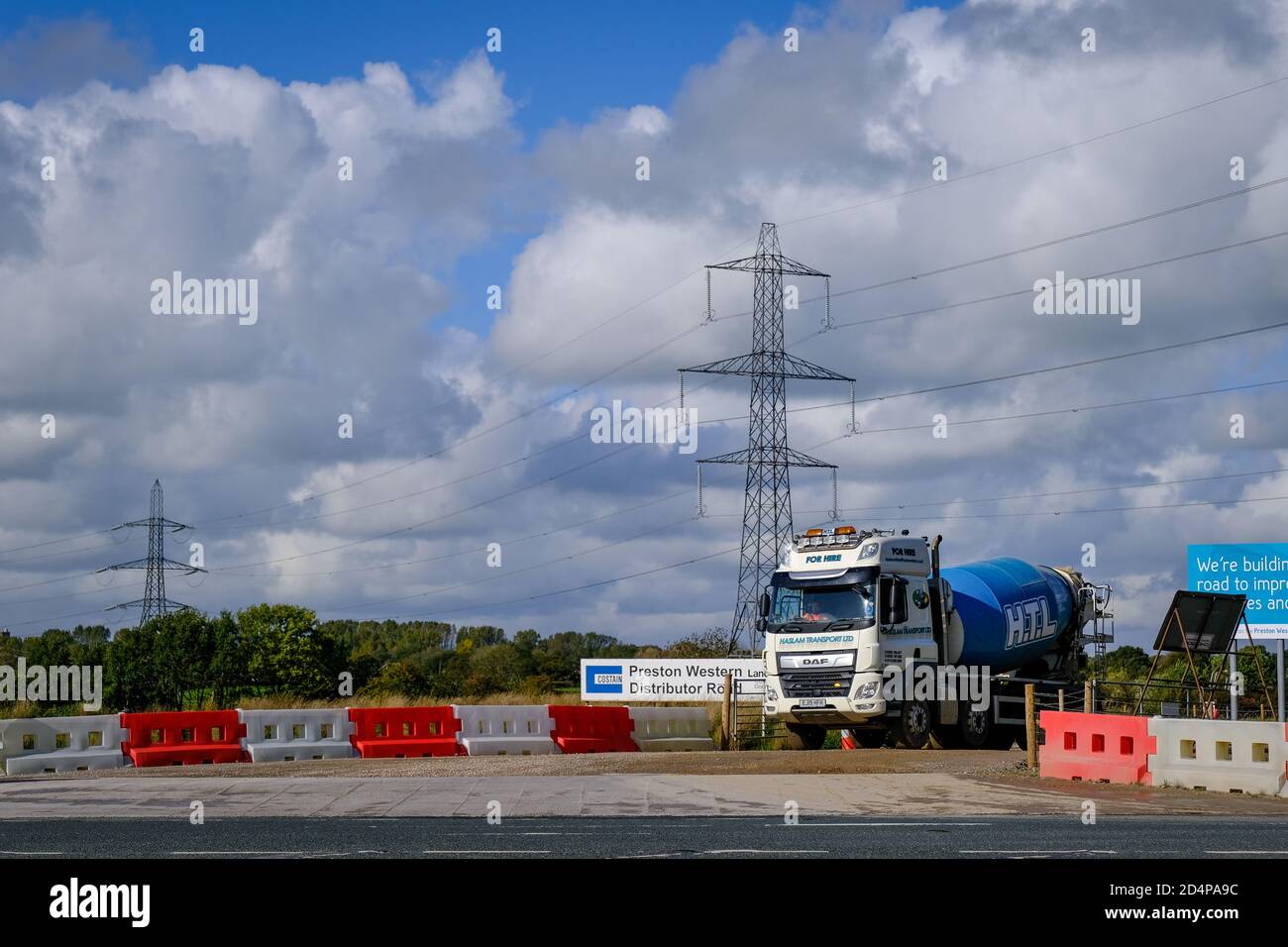 A cement mixer exiting the construction site for the Preston Western Distributor Road which links up to the M55 Motorway Stock Photo