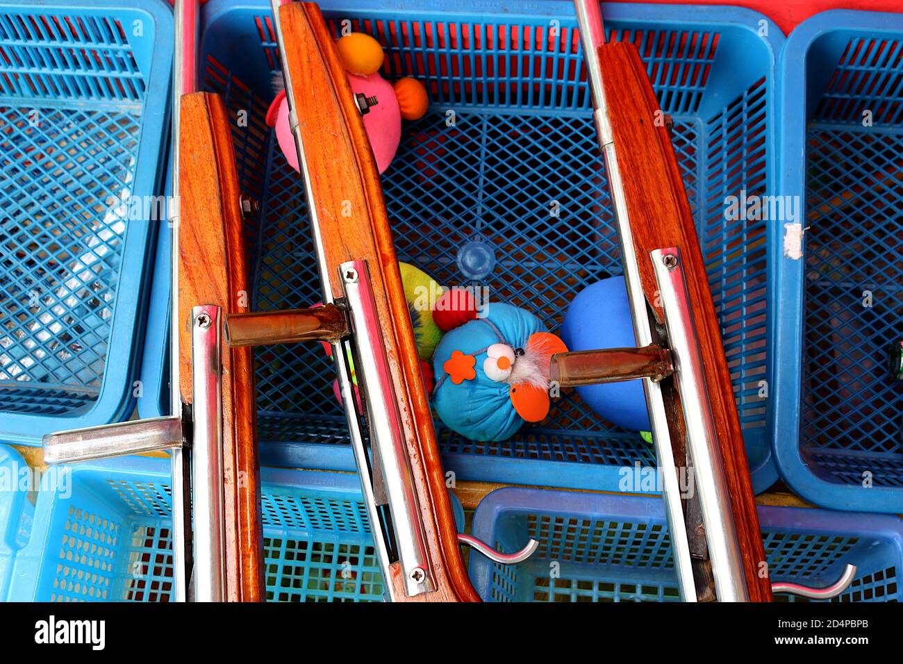 Fish sauce stopper gun. Gun for shoot temple fair doll. Placed on a basket with fish sauce stopper and temple fair doll that can shoot. Stock Photo