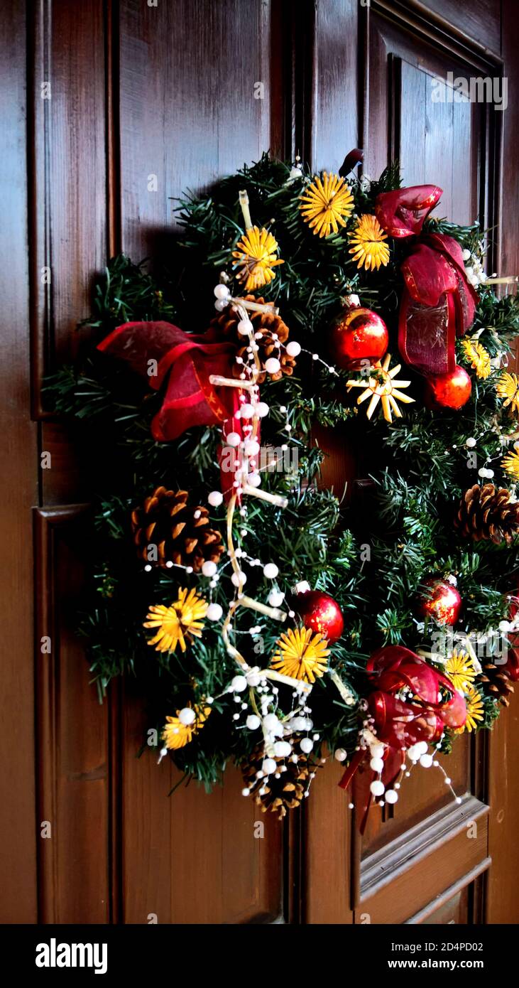 Front wooden door with christmas wreath - close up Stock Photo