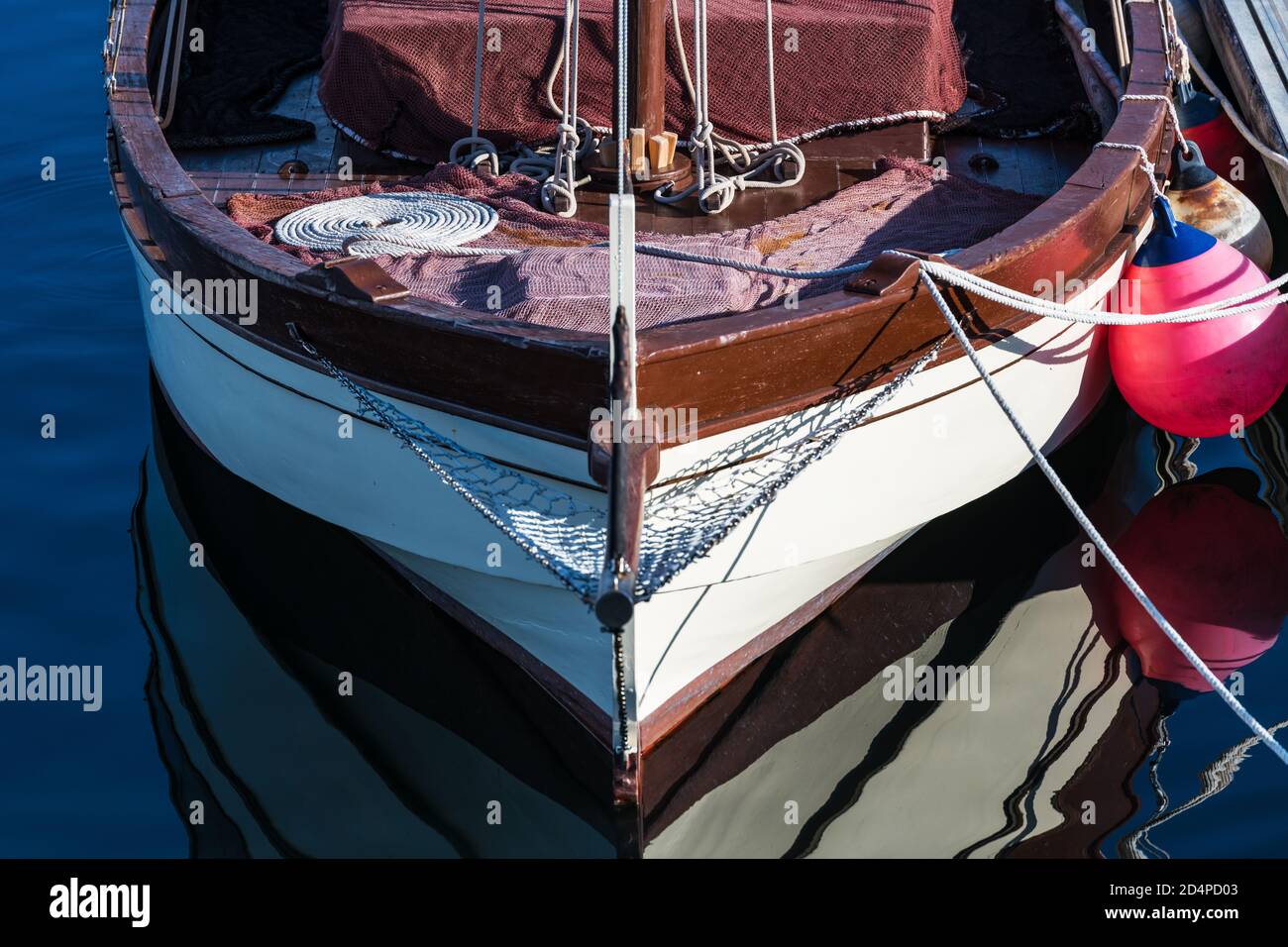 Small sailing boat moored in the yacht club of Portonovo on a clear Summer day, Pontevedra, Spain. Stock Photo