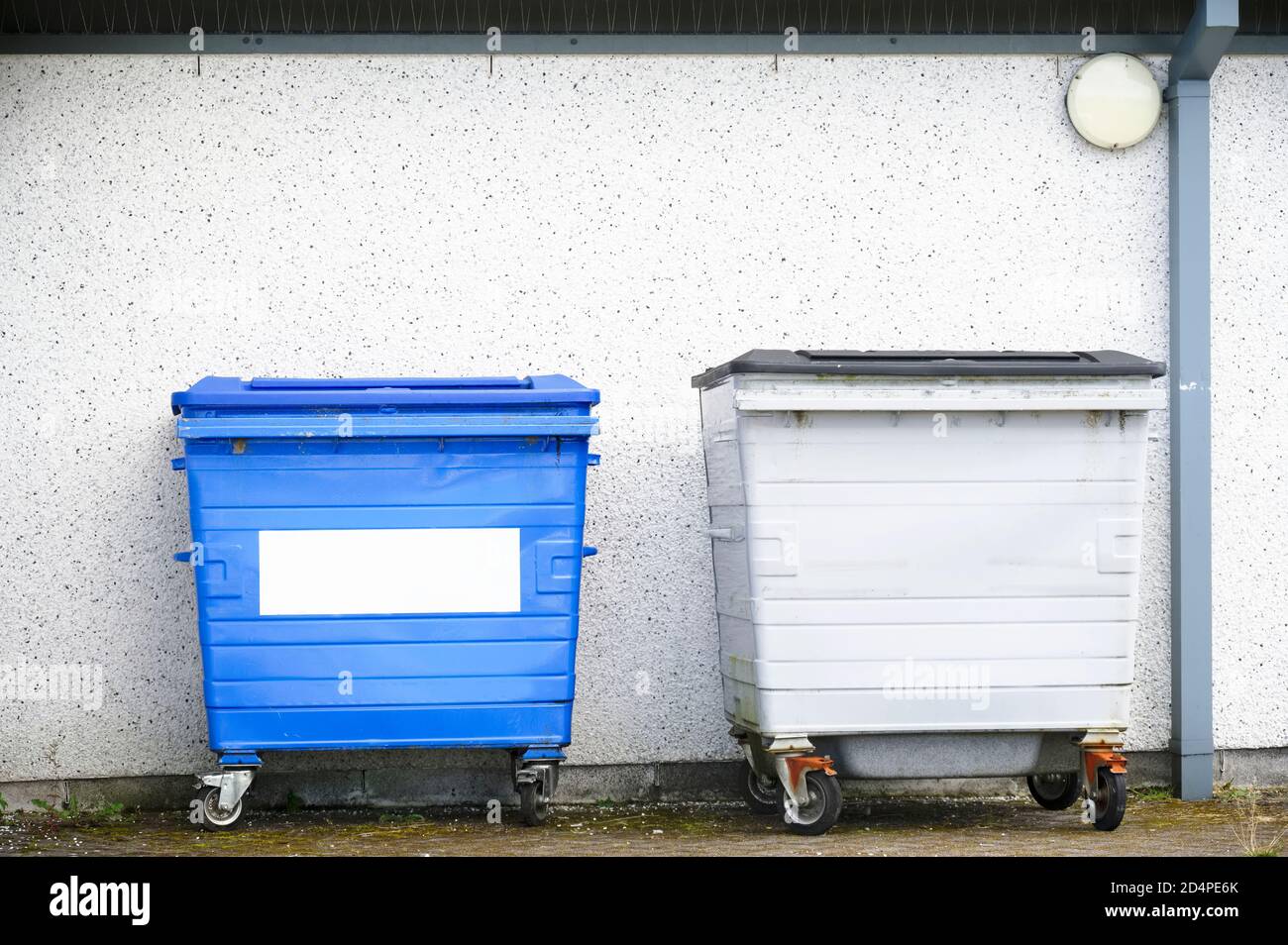 Blue recycle wheelie bins in row for collection outside house Stock