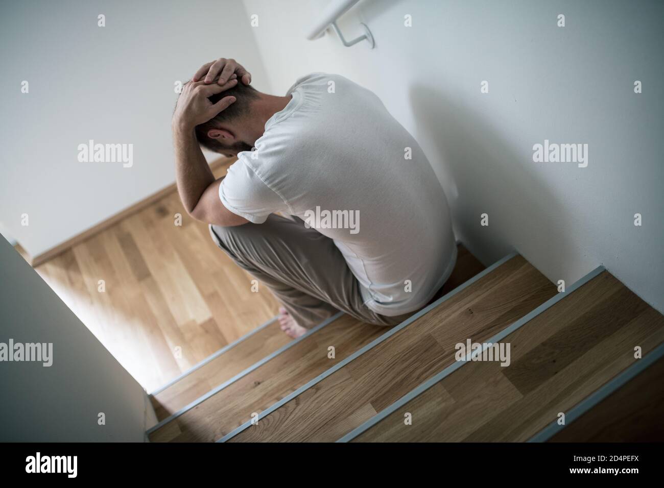 Depressed young man at home worried about finances Stock Photo