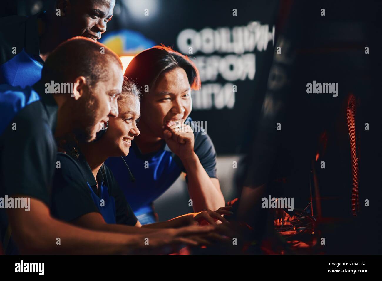 We are winners. Team of happy professional cybersport gamers looking at PC screen and feeling excited and happy while participating in eSport tournament Stock Photo