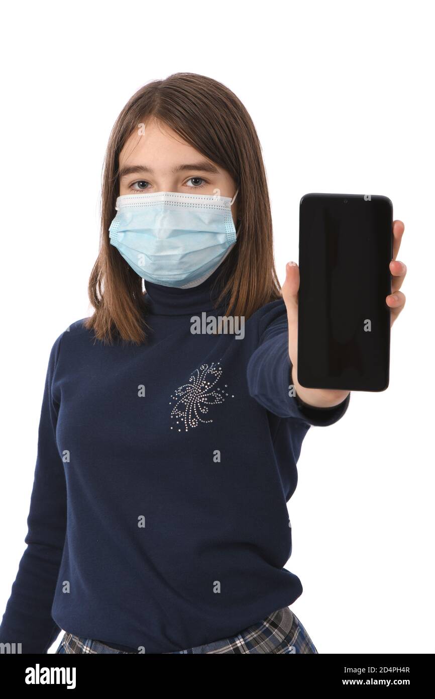 Pre-adolescent girl holding black smartphone with blank screen. isolated on white background. High resolution photo. Full depth of field. Stock Photo