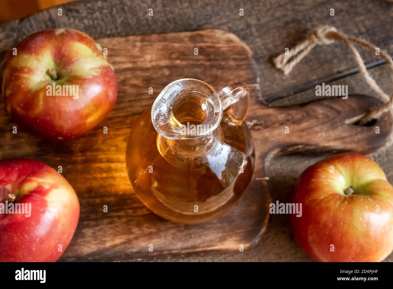 A bottle of apple cider vinegar on a table Stock Photo - Alamy
