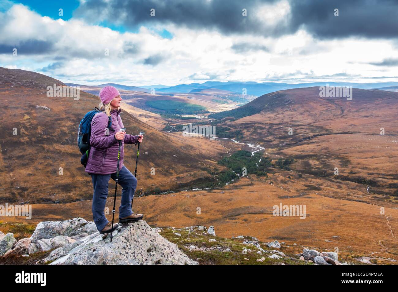 Walker on the hills looking back towards Glen Lui in Aberdeenshire, Scotland, UK Stock Photo