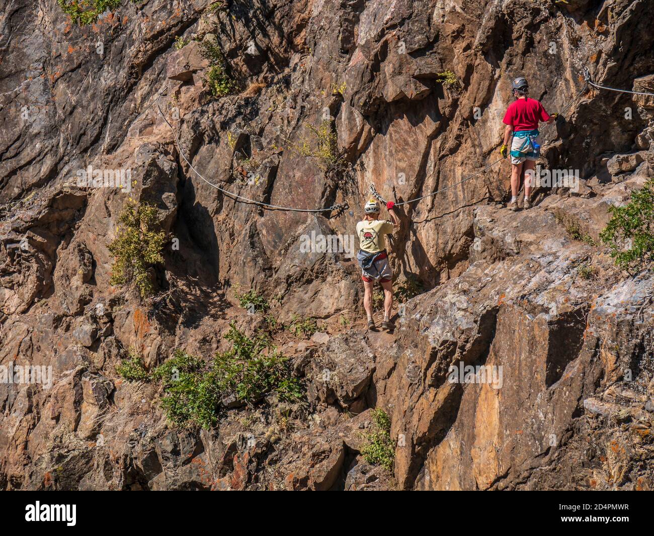 Couple climb the Ouray Via Ferrata, Ouray, Colorado. Stock Photo