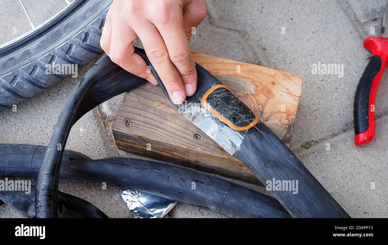 make bicycle tire repair, a person is repairing a puncture bicycle inner  tubes Stock Photo - Alamy