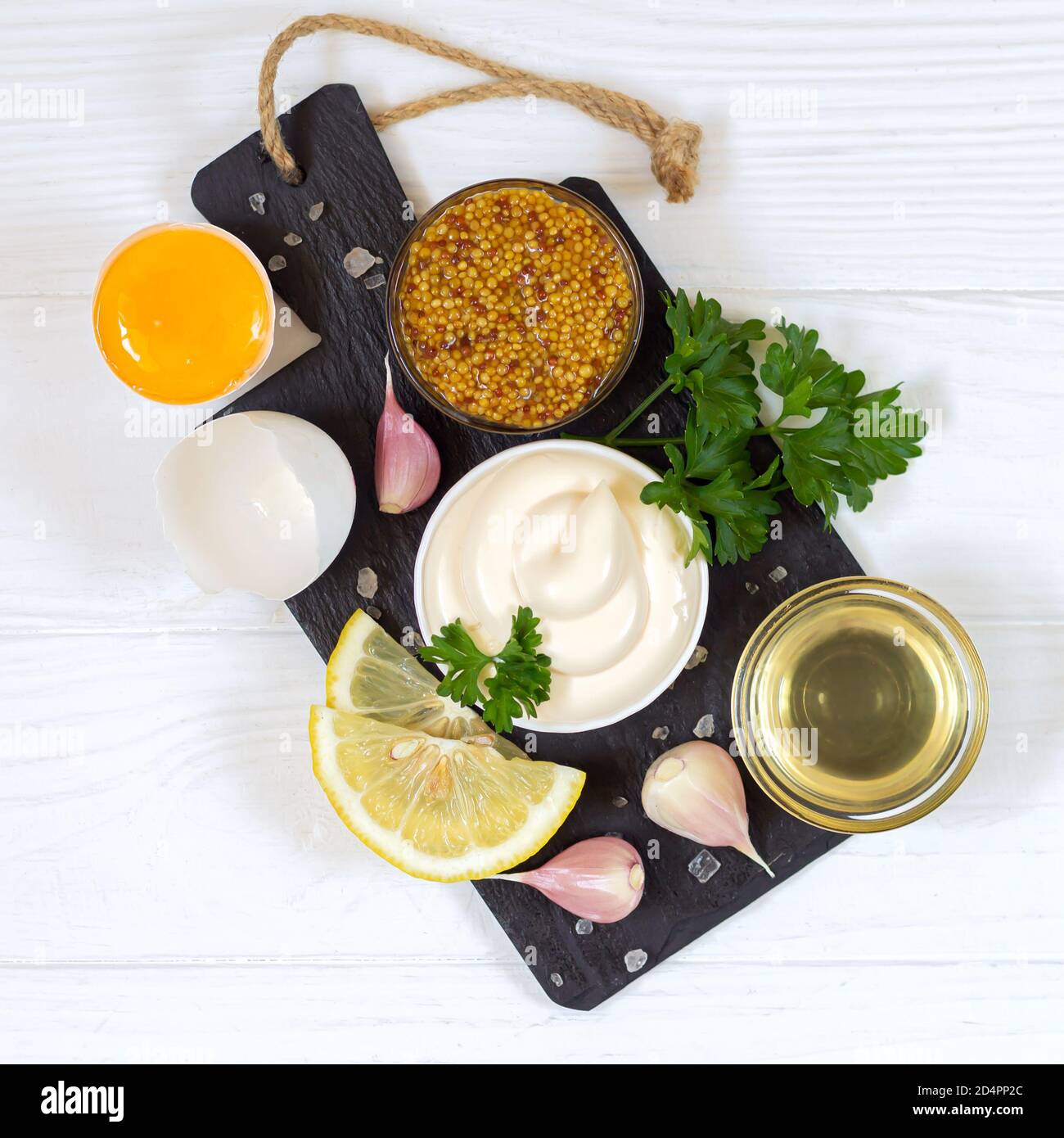Ingredients for making mayonnaise sauce on stone board top view Stock
