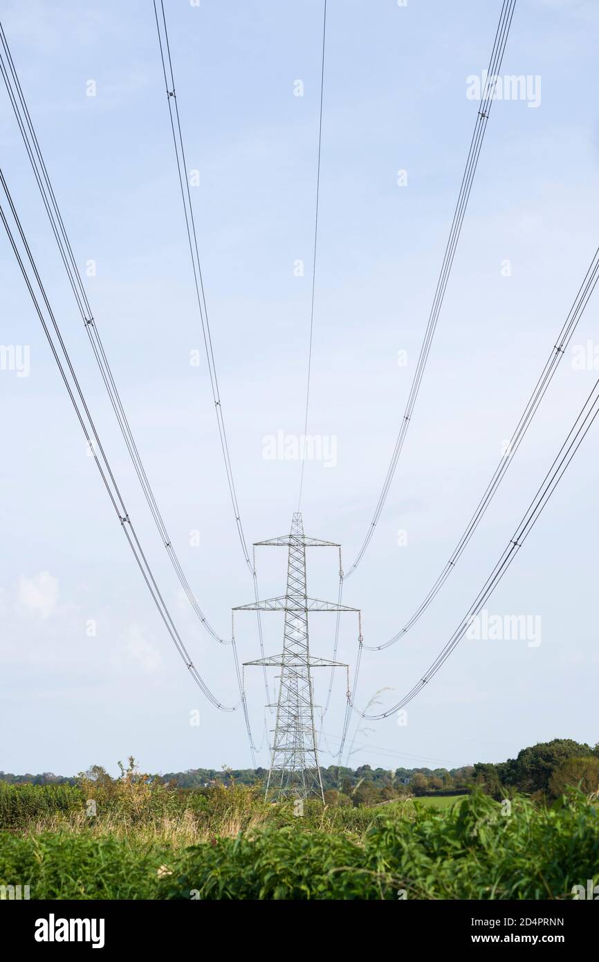 An electricity pylon and electrical transmission cables in a rural