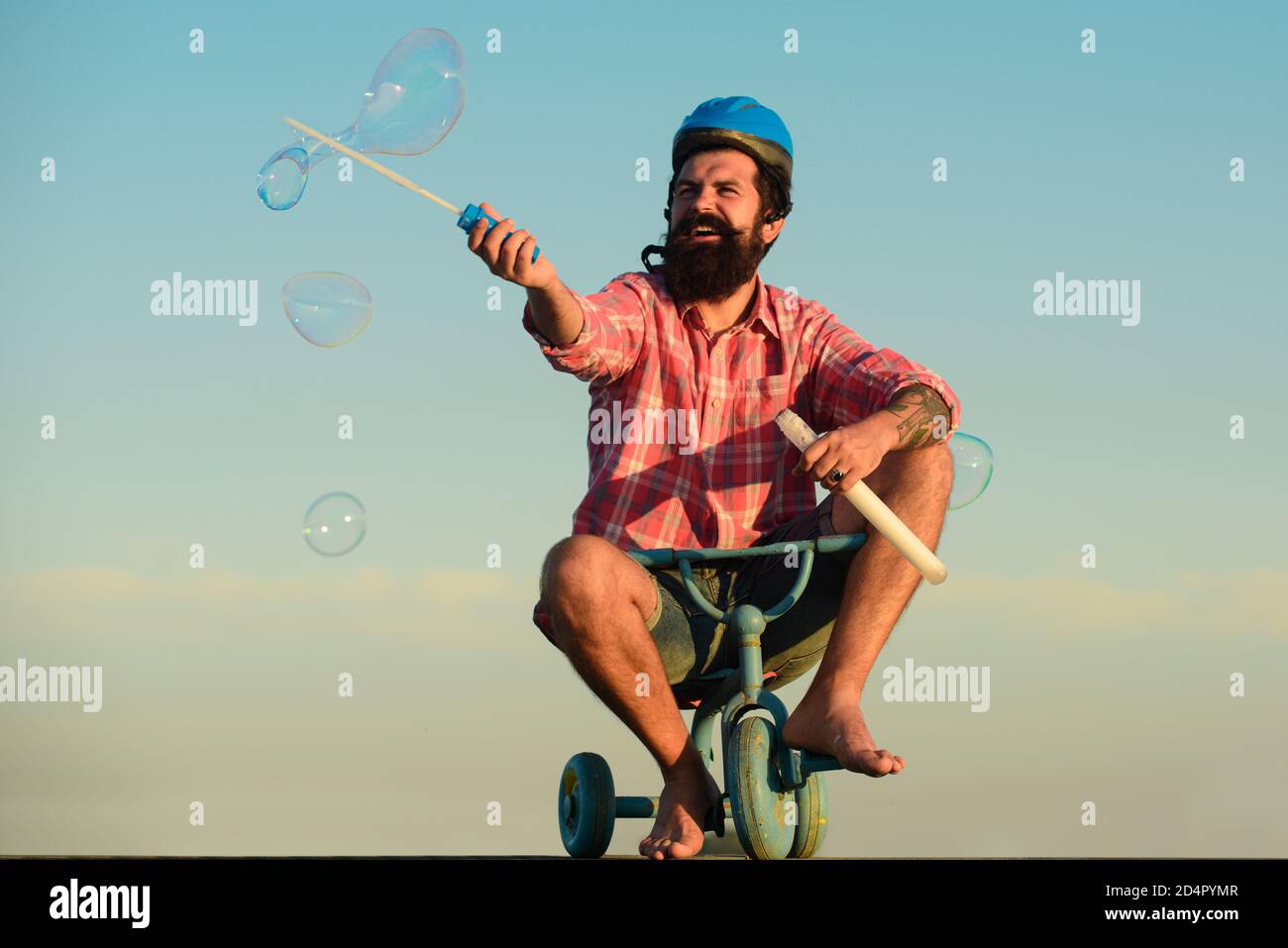 Childhood memory. Funny crazy man riding a bike Stock Photo - Alamy