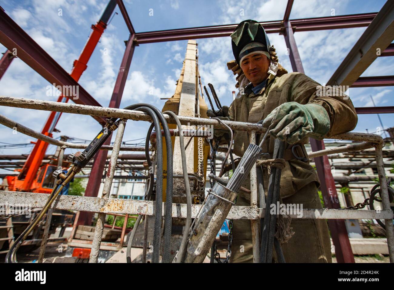 Shymkent/Kazakhstan - April 27 2012: Construction of new industrial building of chemical pharmaceutical plant Santo. Welder worker at work. Stock Photo