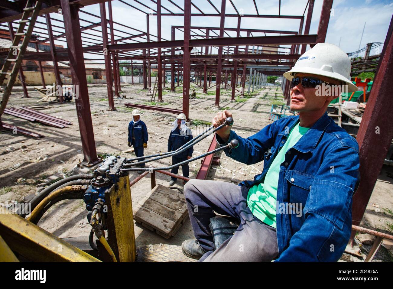 Shymkent/Kazakhstan - April 27 2012: Construction of new industrial building. Crane operator at work. Stock Photo