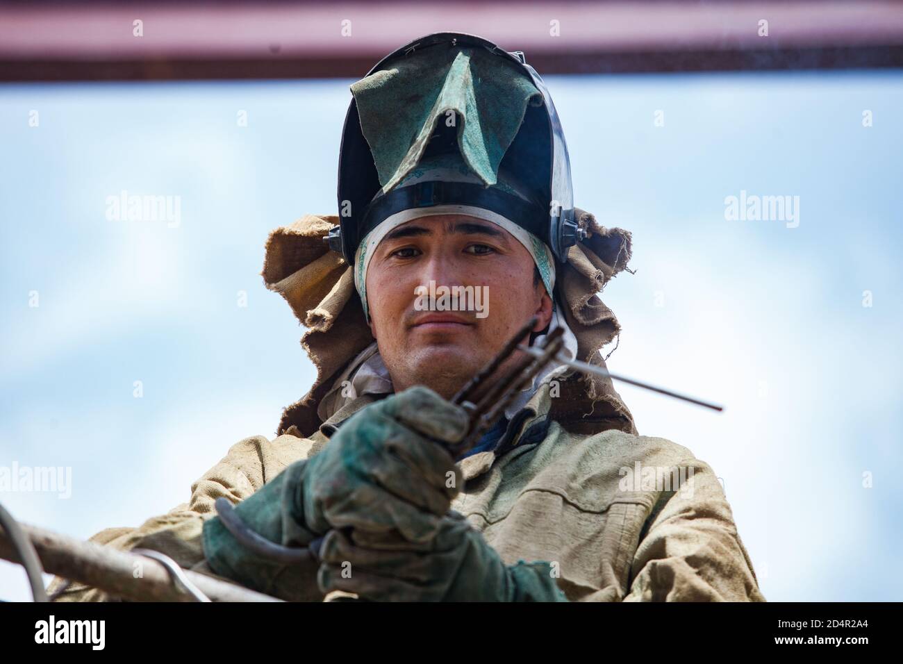 Shymkent/Kazakhstan - April 27 2012: Construction of new industrial building of chemical pharmaceutical plant Santo. Welder worker at work. Stock Photo