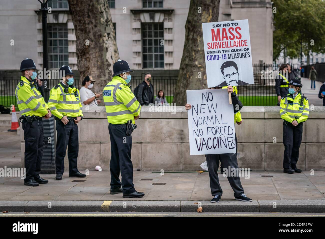 London, UK. 10th October, 2020. Anti-covid19 protesters rally opposite Downing Street under a heavy police presence as part of on-going demonstrations against the current government imposed Coronavirus restrictions. The conspiracy theorists continue to claim the pandemic is an orchestrated hoax and demand no further lockdown regulations, no social distancing, no masks, no track and trace, no health passports, no mandatory vaccinations and no 'new normal'. Credit: Guy Corbishley/Alamy Live News Stock Photo