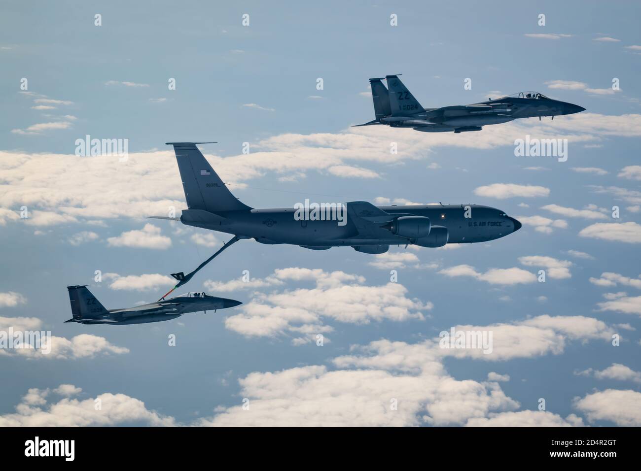 Two F-15C Eagles from the 44th Fighter Squadron refuel with a KC-135 Stratotanker from the 909th Air Refueling Squadron Jan. 10, 2020, during exercise WestPac Rumrunner out of Kadena Air Base, Japan. Rumrunner represents an evolution in the capabilities of 18th Wing assets to work with joint partners to defend American allies and ensures a free-and open Indo-Pacific region. (U.S. Air Force photo by Senior Airman Matthew Seefeldt) Stock Photo