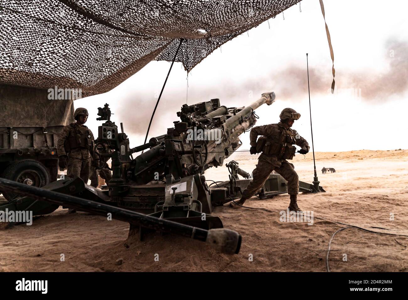 U.S. Marines with Charlie Battery, 1st Battalion, 10th Marine Regiment, 2nd Marine Division, fire a M777 Howitzer during Integrated Training Exercise (ITX) 2-20 at Marine Corps Air Ground Combat Center, Twentynine Palms, Calif., Jan. 20, 2020. The purpose of ITX is to create a challenging, realistic training environment that produces combat-ready forces and to prepare units for their role in the Marine Air Ground Task Force Warfighting Exercise. (U.S. Marine Corps photo by Lance Cpl. Colton Brownlee) Stock Photo