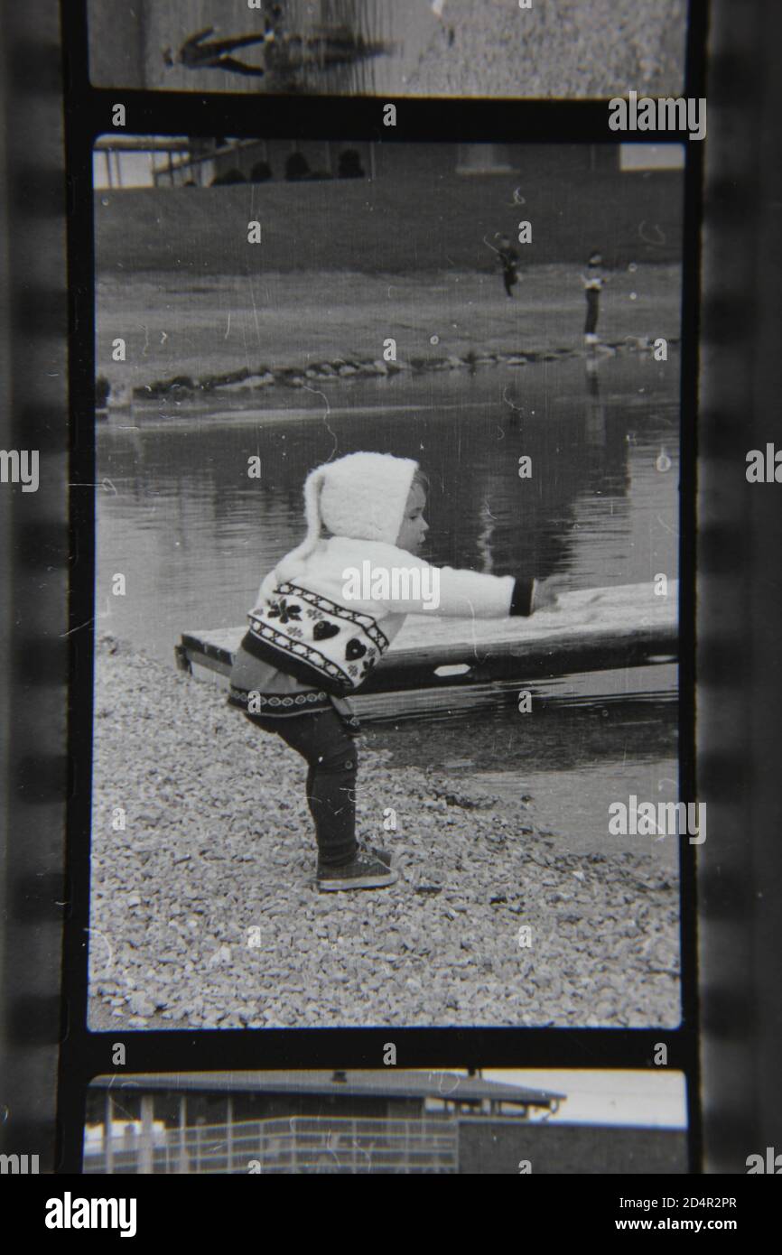 Fine 1970s vintage black and white photography of a little kid enjoying Lake Park in Des Plaines, Illinois. Stock Photo