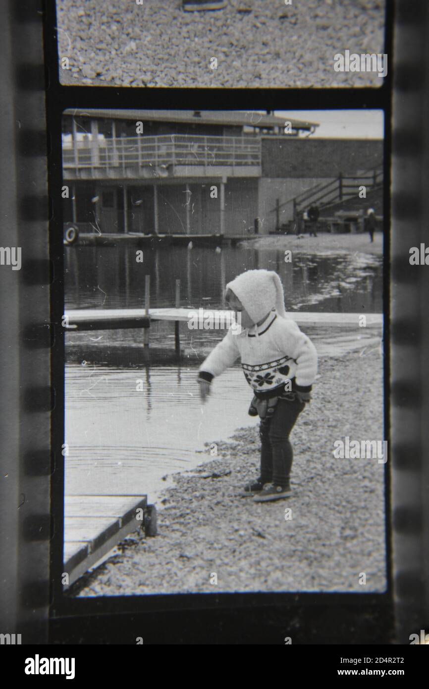 Fine 1970s vintage black and white photography of a little kid enjoying Lake Park in Des Plaines, Illinois. Stock Photo